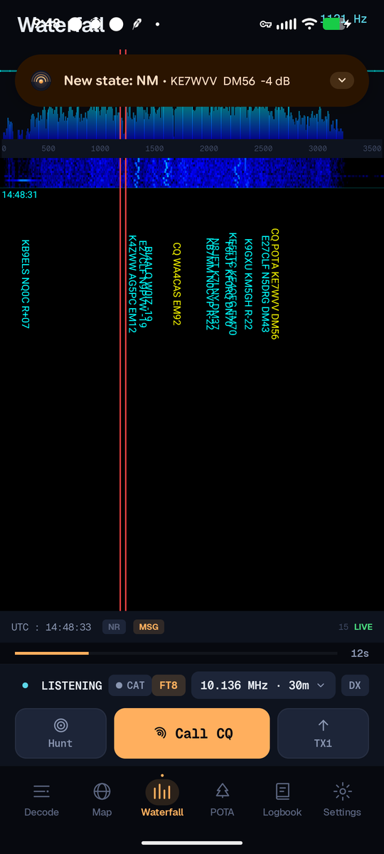 FT8AF Waterfall tab: a full-band spectrogram with decoded callsigns stamped vertically on their signals, a TX-frequency marker, a UTC timestamp, and an active QSO state banner reading 'New state: NM · KE7WVV DM56 −4 dB'.